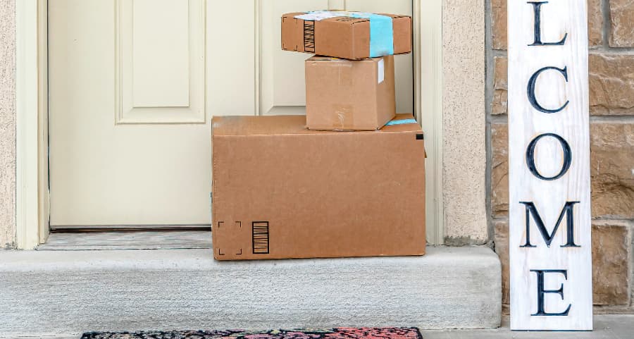 Boxes by the door of a residence with a welcome sign in Jacksonville